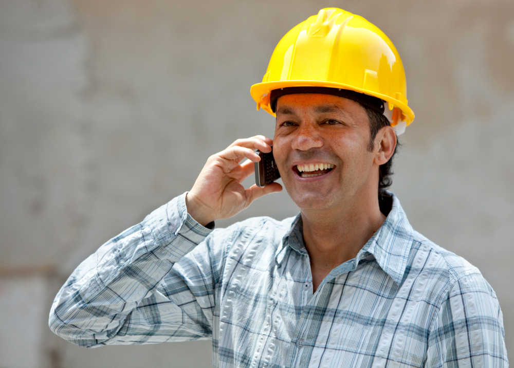 Construction worker talking on the phone at a building site